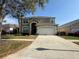 Charming two-story home featuring a two-car garage and well-maintained landscaping in a residential neighborhood at 2677 Emerald Island Blvd, Kissimmee, FL 34747