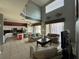 Bright and airy living room featuring high ceilings, tile floors, and an open floor plan to the kitchen at 2677 Emerald Island Blvd, Kissimmee, FL 34747