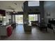 Open-concept living space with views of the pool, featuring tile flooring and plenty of natural light at 2677 Emerald Island Blvd, Kissimmee, FL 34747