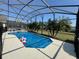 Screened-in pool with a covered enclosure and a patio, perfect for outdoor entertaining at 2677 Emerald Island Blvd, Kissimmee, FL 34747