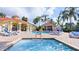 Resort-style pool area with lounge chairs and palm trees at the community clubhouse at 2677 Emerald Island Blvd, Kissimmee, FL 34747