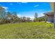 Expansive backyard with lush lawn, a covered patio, and ample space for outdoor activities and entertainment at 2700 Sw 162Nd St Rd, Ocala, FL 34473