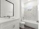 Modern bathroom with white marbled shower and vanity with chrome hardware and black framed mirror at 2700 Sw 162Nd St Rd, Ocala, FL 34473