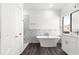 Bright bathroom with a freestanding tub, white cabinets and attractive marble-look shower tile at 2700 Sw 162Nd St Rd, Ocala, FL 34473