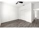 This bedroom features a modern ceiling fan, light grey wood-style floors and a closet at 2700 Sw 162Nd St Rd, Ocala, FL 34473