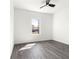 Well-lit bedroom features sleek ceiling fan, with light grey wood-style flooring and neutral walls at 2700 Sw 162Nd St Rd, Ocala, FL 34473