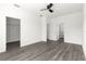 Spacious bedroom featuring a ceiling fan, walk-in closet and modern gray flooring at 2700 Sw 162Nd St Rd, Ocala, FL 34473