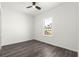 A bright, clean bedroom with wood-look floors, a ceiling fan and a window at 2700 Sw 162Nd St Rd, Ocala, FL 34473