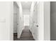 Long, bright hallway with light grey wood-style floors connecting different rooms in the home at 2700 Sw 162Nd St Rd, Ocala, FL 34473