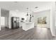 A bright and modern open-concept kitchen featuring stainless steel appliances and an island at 2700 Sw 162Nd St Rd, Ocala, FL 34473