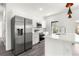Bright kitchen features stainless steel appliances, white cabinetry, and a stylish island with a sink at 2700 Sw 162Nd St Rd, Ocala, FL 34473