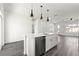 Kitchen island with stainless steel dishwasher and sink, with view of living room and exterior at 2700 Sw 162Nd St Rd, Ocala, FL 34473