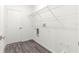 A clean laundry room featuring a wire shelf and new grey wood-style flooring at 2700 Sw 162Nd St Rd, Ocala, FL 34473