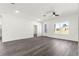 Large living room with a ceiling fan and wood-look floors, looking out on front yard at 2700 Sw 162Nd St Rd, Ocala, FL 34473