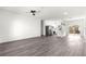 Bright, open-concept living space with sleek gray wood floors, modern fixtures, and abundant natural light at 2700 Sw 162Nd St Rd, Ocala, FL 34473