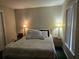 Cozy bedroom featuring a comfortable bed with two lamps and natural light from a window at 2706 Club Cortile Cir, Kissimmee, FL 34746