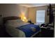 Bedroom featuring a comfortable bed, flat screen TV, and natural light from a window at 2706 Club Cortile Cir, Kissimmee, FL 34746