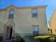 Two-story townhouse exterior featuring a decorative facade and well-maintained landscaping at 2706 Club Cortile Cir, Kissimmee, FL 34746
