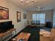 Inviting living room with green carpet, large window, ceiling fan, and comfortable seating at 2706 Club Cortile Cir, Kissimmee, FL 34746