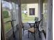 Screened patio featuring outdoor seating, a small table, and an electric scooter at 2706 Club Cortile Cir, Kissimmee, FL 34746