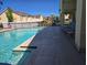 Community pool featuring lounge chairs, clear blue water, and access to community playground at 2706 Club Cortile Cir, Kissimmee, FL 34746
