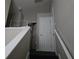 A view of the upper level with a short railing overlooking the lower staircase and multiple doorways at 2706 Club Cortile Cir, Kissimmee, FL 34746