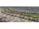 Aerial view of multiple properties in a community with lush landscaping and a pond nearby at 2719 River Creek Ln, St Cloud, FL 34771