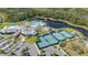 Aerial view of community pool, tennis courts, clubhouse and manicured landscaping at 2719 River Creek Ln, St Cloud, FL 34771