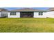Manicured back yard with a view of the home's screened-in porch at 2719 River Creek Ln, St Cloud, FL 34771