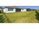 Expansive and manicured back yard featuring a screened porch and privacy landscaping at 2719 River Creek Ln, St Cloud, FL 34771