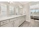 Elegant bathroom featuring double vanity, quartz countertops, and seamless glass shower at 2719 River Creek Ln, St Cloud, FL 34771