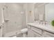 Bathroom featuring a walk-in shower and vanity with gray cabinets and a quartz countertop at 2719 River Creek Ln, St Cloud, FL 34771