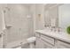 Modern bathroom featuring a glass-enclosed shower, a stylish vanity, and neutral-toned tile at 2719 River Creek Ln, St Cloud, FL 34771