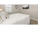 Serene bedroom with a bed dressed in white linens and decor hanging above the bed at 2719 River Creek Ln, St Cloud, FL 34771