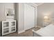 Bright bedroom featuring white furniture, a sliding-door closet, and wood-look tile flooring at 2719 River Creek Ln, St Cloud, FL 34771