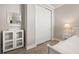 Bright bedroom featuring a white cabinet with glass doors and wood-look floors at 2719 River Creek Ln, St Cloud, FL 34771