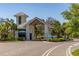View of the Del Webb Sunbridge community entrance with a guard house and manicured landscaping at 2719 River Creek Ln, St Cloud, FL 34771