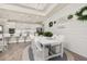 Open concept dining area with white table set, decor, and views into the kitchen at 2719 River Creek Ln, St Cloud, FL 34771