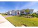 Single-story home featuring a brick-paved driveway and landscaped front yard under a clear blue sky at 2719 River Creek Ln, St Cloud, FL 34771