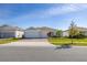 Charming single-Gathering home featuring a three-car garage and well-manicured front yard at 2719 River Creek Ln, St Cloud, FL 34771