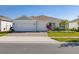 Charming single-story home featuring a three-car garage, paver driveway, and manicured lawn at 2719 River Creek Ln, St Cloud, FL 34771