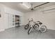 Clean garage with epoxy floors, shelving, and space for bicycles at 2719 River Creek Ln, St Cloud, FL 34771
