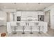 Spacious kitchen with an island, white cabinetry, stainless appliances, and modern pendant lighting at 2719 River Creek Ln, St Cloud, FL 34771