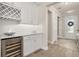 Modern butler's pantry with wine cooler, white cabinetry, and beverage center at 2719 River Creek Ln, St Cloud, FL 34771