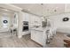 Modern kitchen with white cabinets, stainless steel appliances, and a large island with seating at 2719 River Creek Ln, St Cloud, FL 34771
