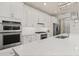 Well-equipped kitchen with stainless steel appliances, white cabinets, and a stylish overhead lighting at 2719 River Creek Ln, St Cloud, FL 34771