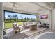 Screened lanai featuring comfortable seating, ceiling fans, and views of the backyard at 2719 River Creek Ln, St Cloud, FL 34771