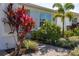 Close-up of vibrant landscaping with a paver walkway and colorful plants at 2719 River Creek Ln, St Cloud, FL 34771