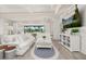 Bright and airy living room featuring white furniture, shiplap walls, and seamless indoor-outdoor living at 2719 River Creek Ln, St Cloud, FL 34771