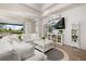 Cozy living room with white sofas, shiplap walls, a ceiling fan, and a view of the backyard at 2719 River Creek Ln, St Cloud, FL 34771